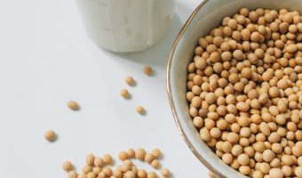 photo of soybeans near drinking glass with soy milk